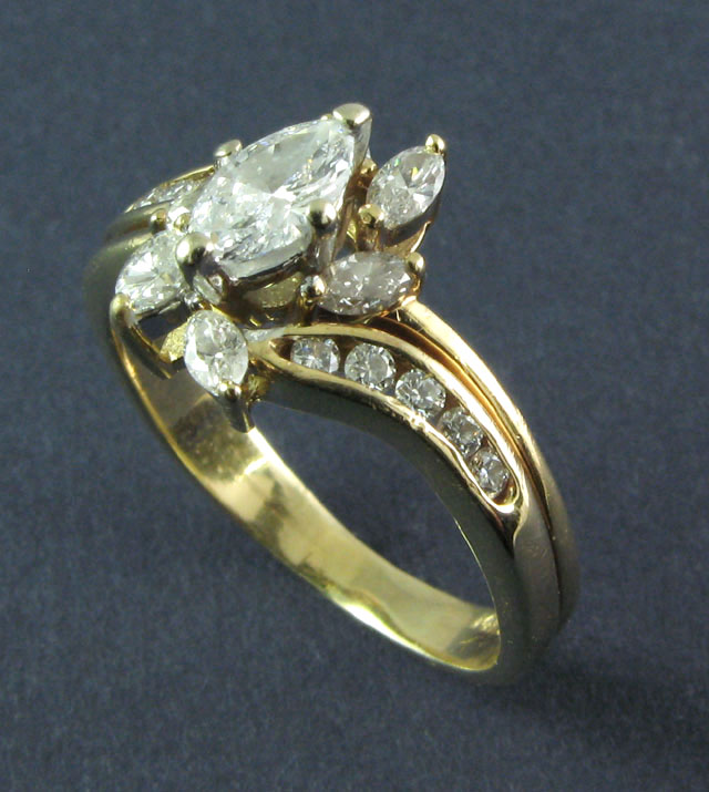 Appraisal: DIAMOND AND FOURTEEN KARAT GOLD RING set with seven marquise-cut