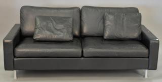 Appraisal: Modern Cor black leather two cushion sofa Modern Cor black