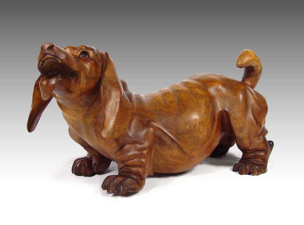 Appraisal: BIGGER THAN LIFE CARVED WOOD DACHSHUND Carved from a single