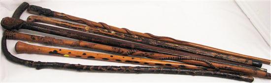 Appraisal: Seven walking sticks two with carved snakes one with figural