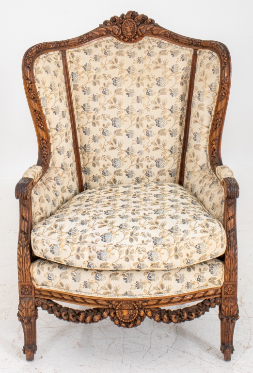 Appraisal: HEAVILY CARVED FRENCH NEOCLASSICAL STYLE ARMCHAIR Upholstered Bergere chair heavily