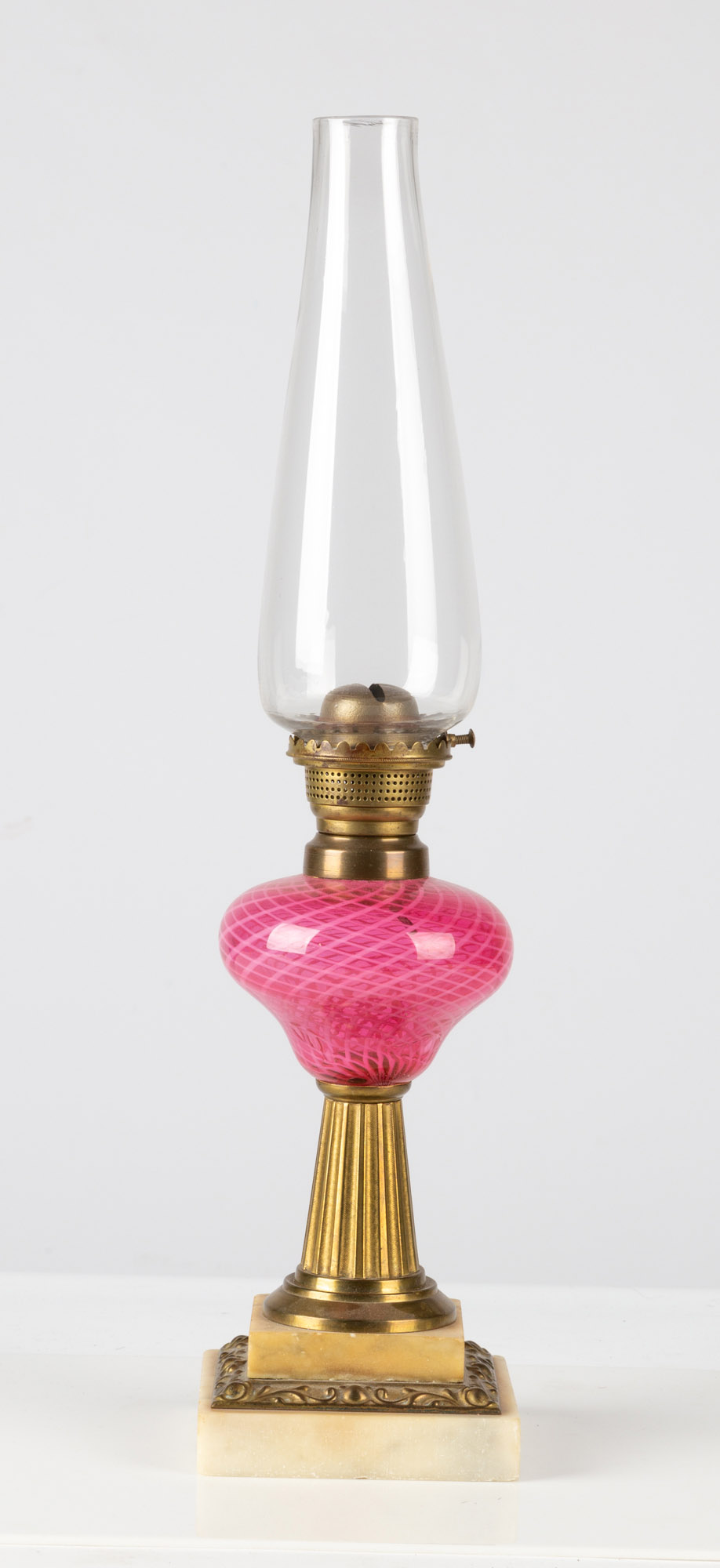 Appraisal: PINK LATTICINIO OIL LAMP circa cranberry glass with swirling white