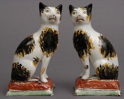 Appraisal: PAIR OF STAFFORDSHIRE FIGURES OF SEATED CATS Each with black