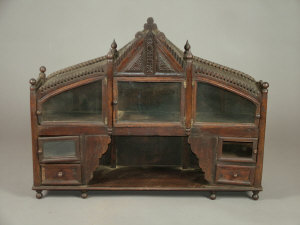 Appraisal: A carved oak display cabinet early th century the triangular