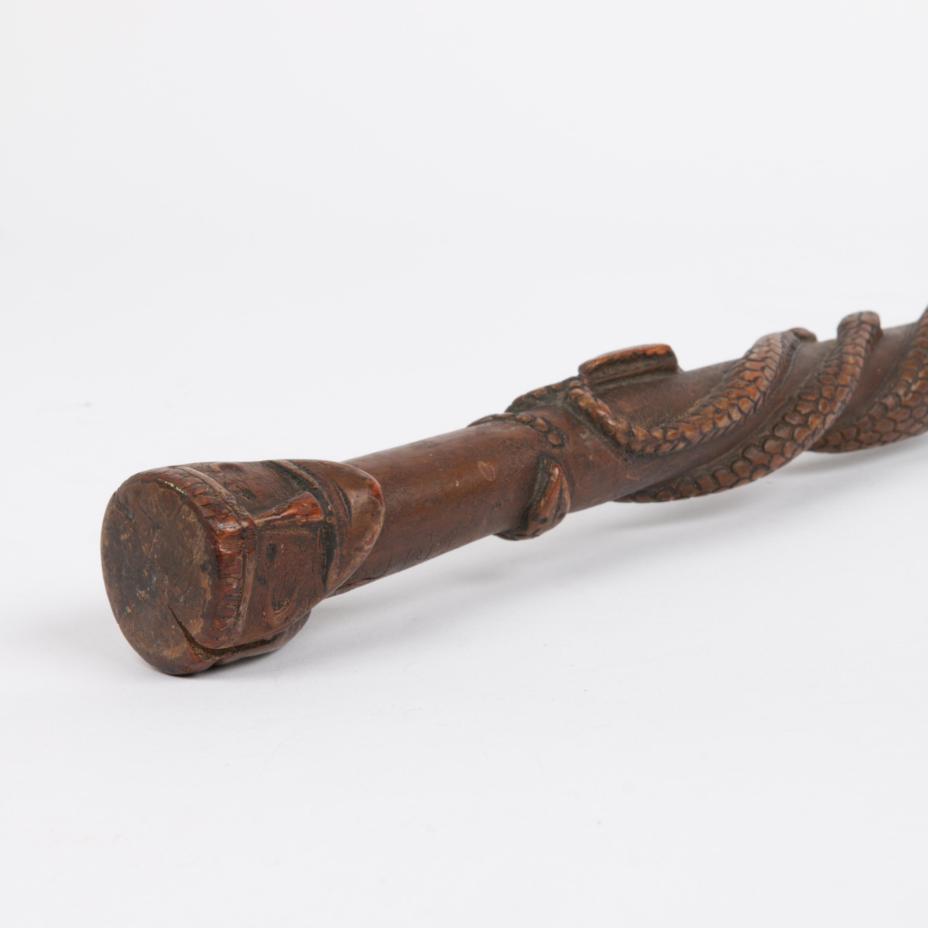 Appraisal: FOLK ART CARVED CANE WITH SNAKES AND HEAD An expertly