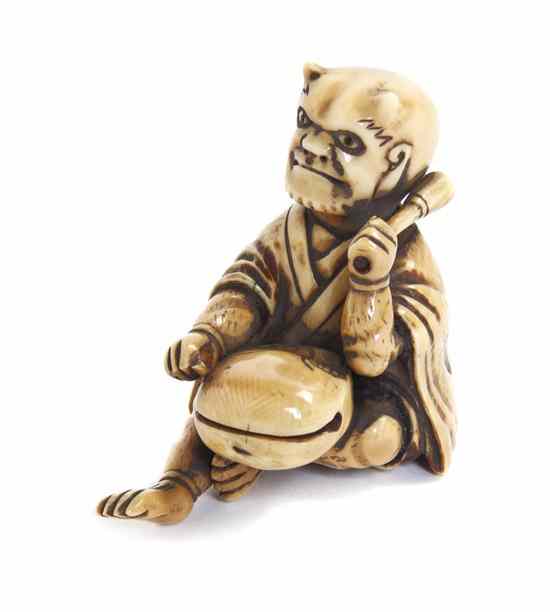 Appraisal: An Ivory Netsuke of an Oni the horned figure shown