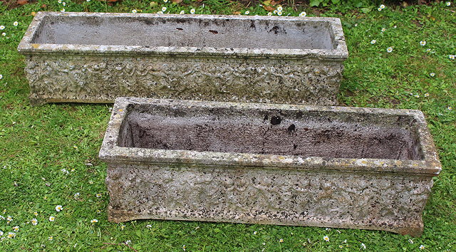 Appraisal: A COMPOSITE STONE RECTANGULAR TROUGH decorated with dancing cherubs cm