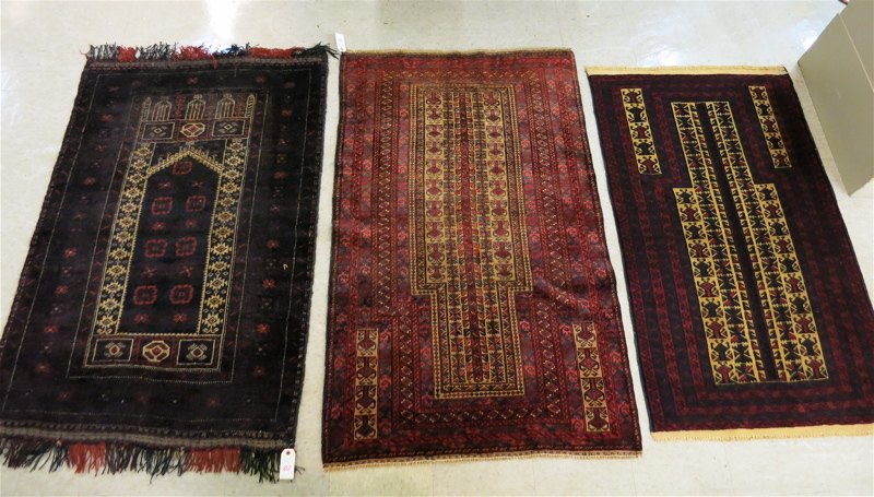 Appraisal: THREE AFGHAN BELOUCHI TRIBAL PRAYER RUGS all hand knotted in