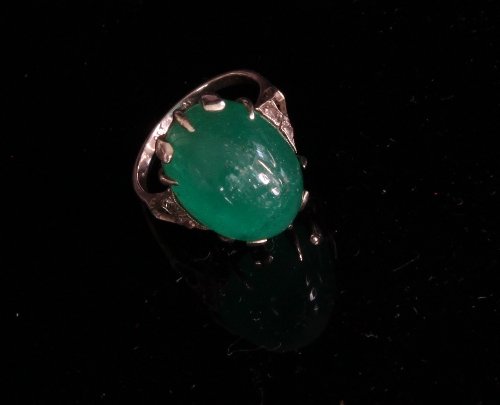 Appraisal: A cabochon emerald ring the oval cabochon to diamond set