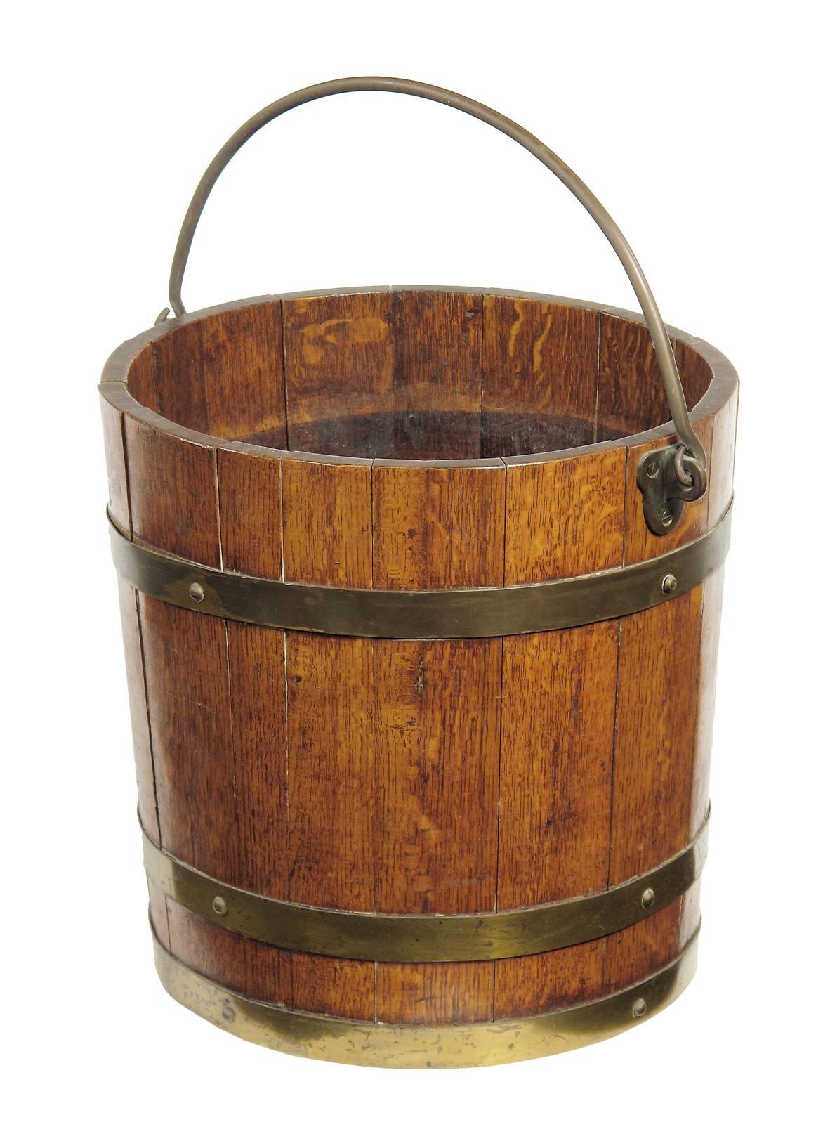 Appraisal: A Victorian staved oak and brass bound bucket