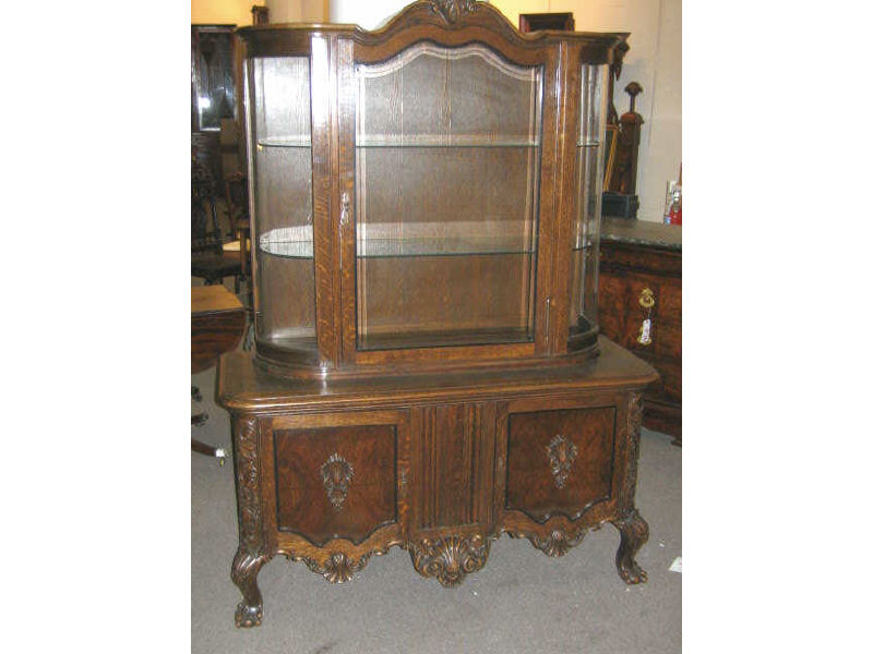 Appraisal: CONTINENTAL OAK CHINA CABINET The top member with floral crest