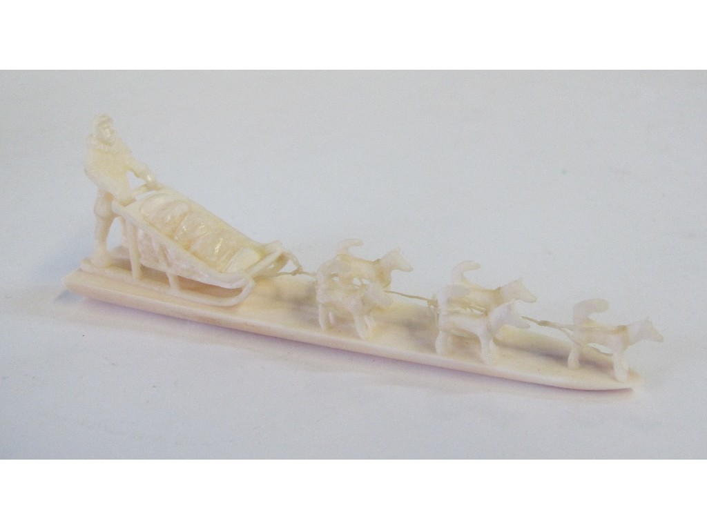 Appraisal: Inuit marine ivory carving of a man sled and dogs