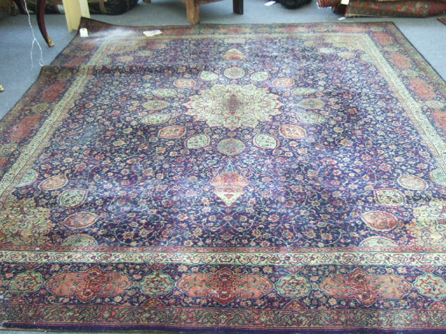 Appraisal: A machine made carpet of Persian design the dark indigo