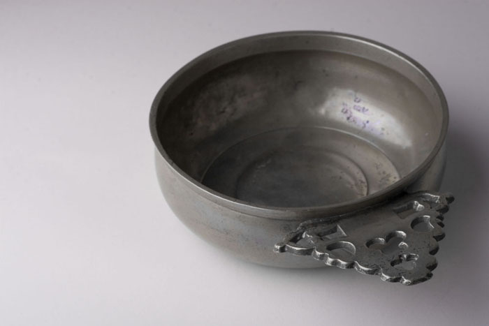 Appraisal: AMERICAN PEWTER PORRINGER Height inches width inches diameter inches Provenance