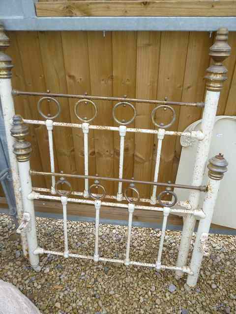 Appraisal: A WHITE PAINTED WROUGHT IRON BED with turned brass finials