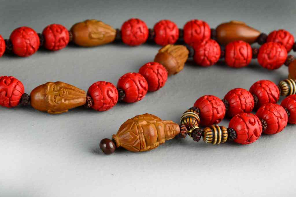 Appraisal: Chinese Carved Bead NecklaceWith simulated carved cinnabar and carve nuts