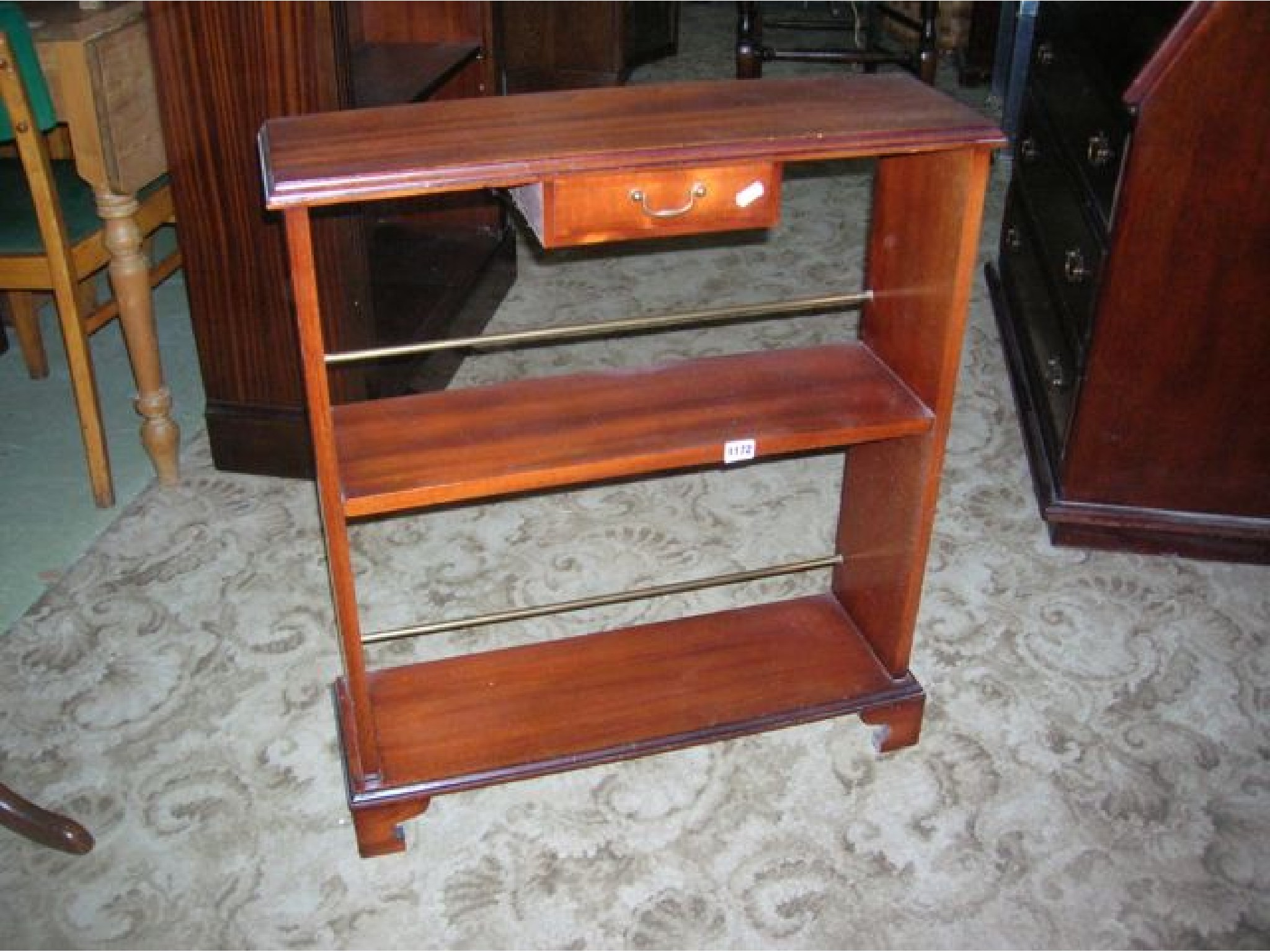 Appraisal: A small mahogany freestanding open bookcase shoe rack in the