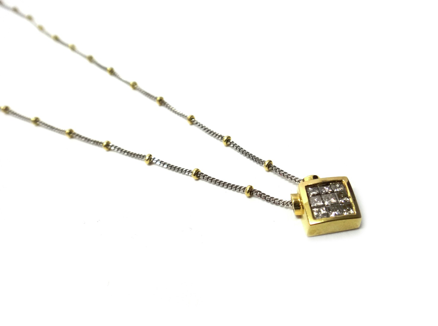 Appraisal: An ct two colour gold and diamond set pendant necklace