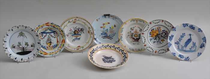 Appraisal: EIGHT FAIENCE AND DELFT PLATES Variously decorated with a crane