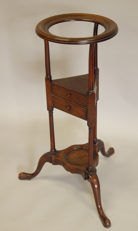 Appraisal: A mahogany washstand in thC style the top with a