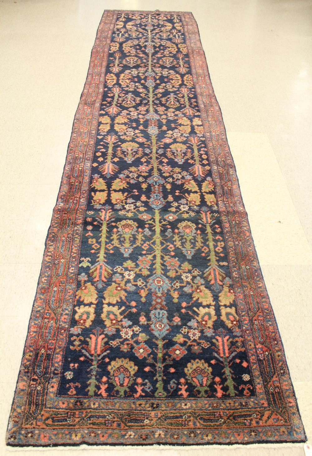 Appraisal: SEMI-ANTIQUE PERSIAN HALL CARPET overall floral design on dark blue