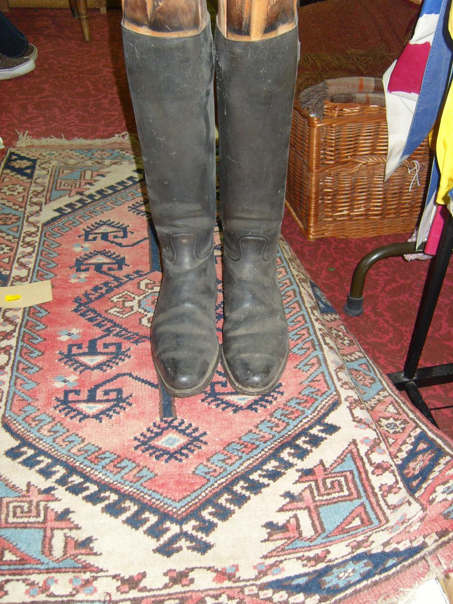 Appraisal: A pair of black leather riding boots complete with wooden