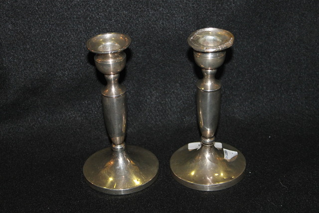 Appraisal: A PAIR OF SILVER CANDLESTICKS with pedestal feet and tapering