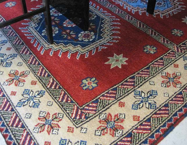 Appraisal: HAND KNOTTED ORIENTAL CARPET Indo-Kazak three geometric medallion design on