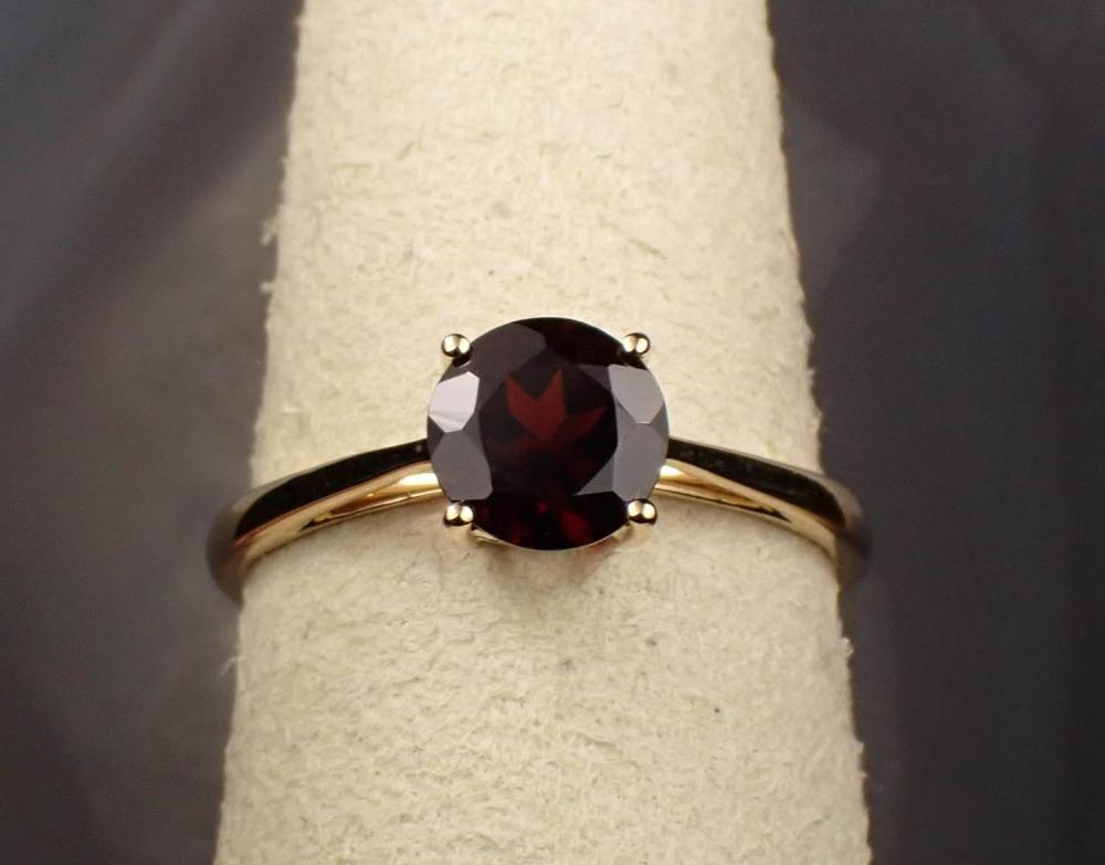 Appraisal: PYROPE GARNET AND FOURTEEN KARAT GOLD RING The yellow gold