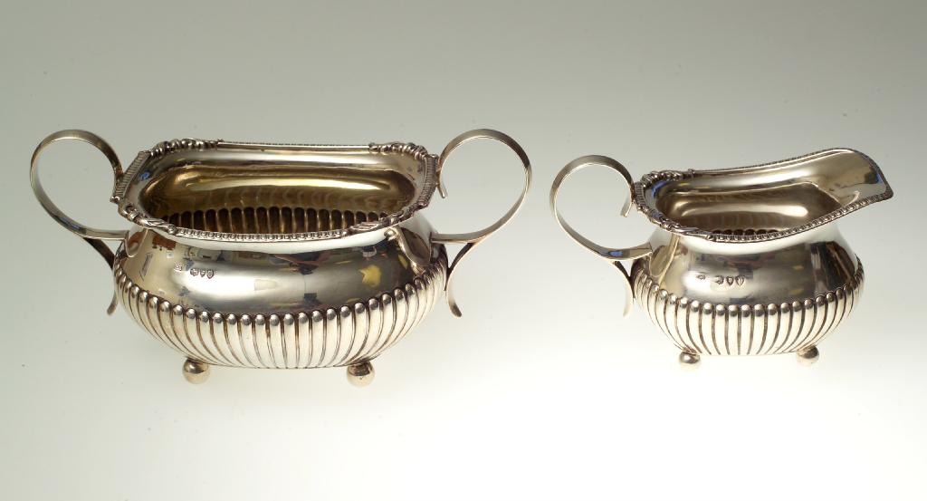 Appraisal: GEORGE III STYLE SILVER TWO-HANDLED SUGAR BOWL AND CREAM JUG