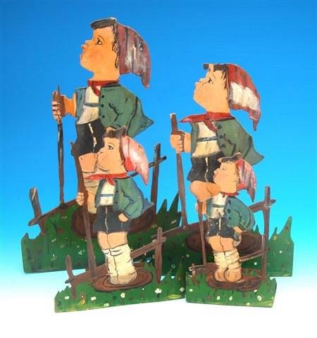 Appraisal: A GROUP OF LAZER FRET-CUT GERMAN 'HUMMEL' FIGURES of a