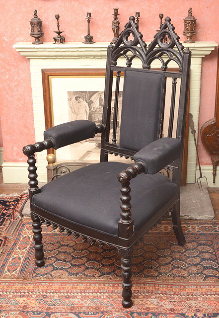 Appraisal: A VICTORIAN EBONISED GOTHIC REVIVAL OPEN ARMCHAIR in the manner