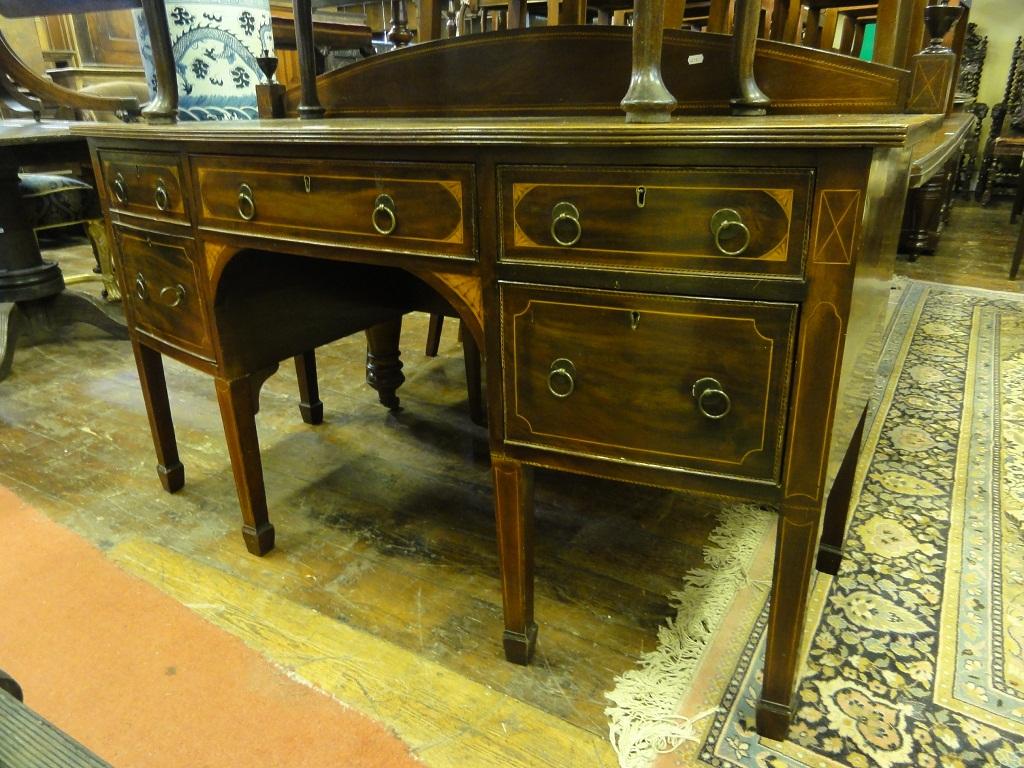 Appraisal: A Georgian mahogany bow fronted sideboard the shallow arched rail