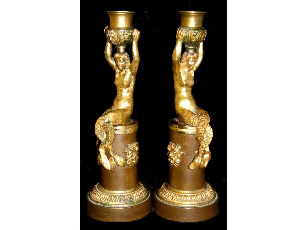 Appraisal: Pair of Regency ormolu candlesticks modelled with mermaids holding aloft