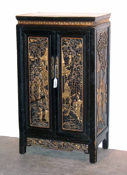 Appraisal: A Chinese gilt and black lacquered two-door cabinet Built with