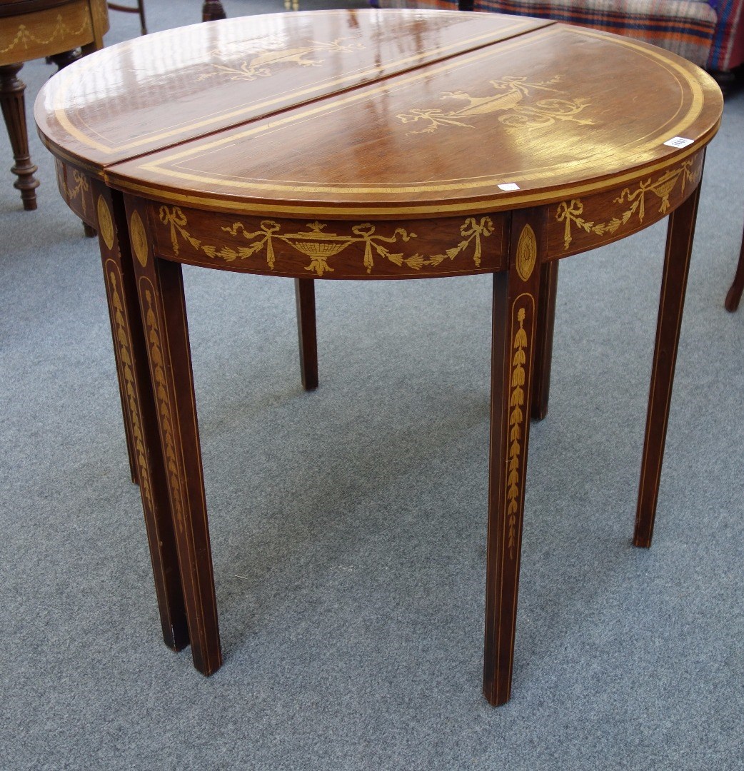 Appraisal: A pair of George III style marquetry inlaid demi-lune console