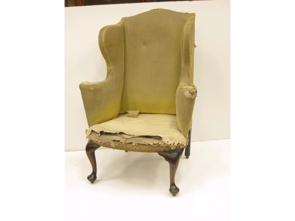 Appraisal: An early th Century Wingback Armchair with shaped arms on