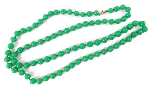 Appraisal: A string of jade coloured glass beads on a knotted