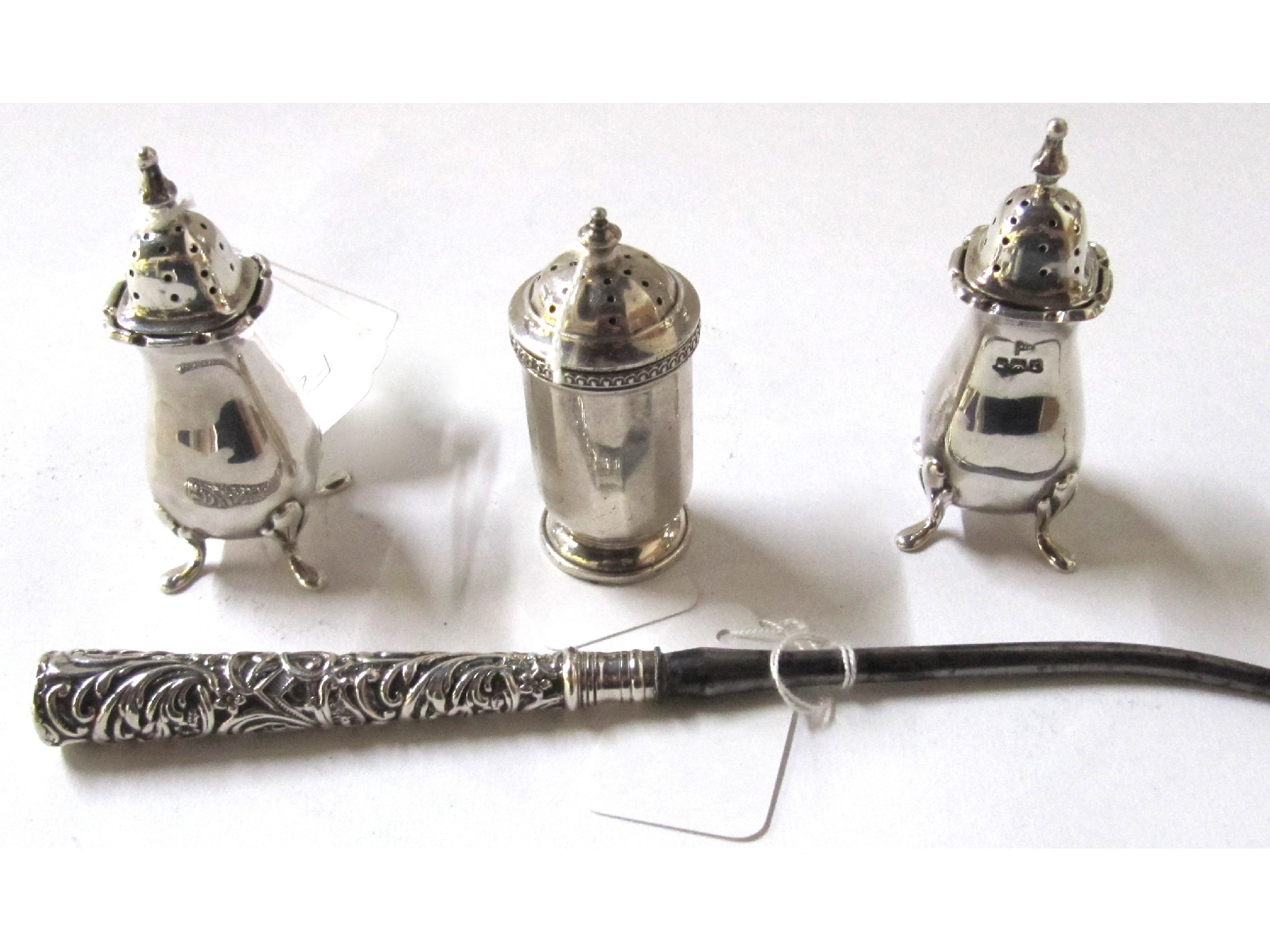 Appraisal: A lot comprising three silver pepper pots and a silver