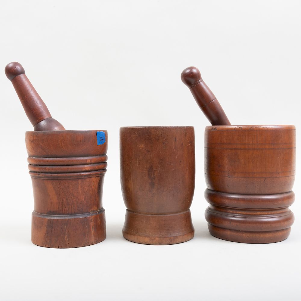 Appraisal: Three Carved Wood Mortars and Two Pestles The largest mortar