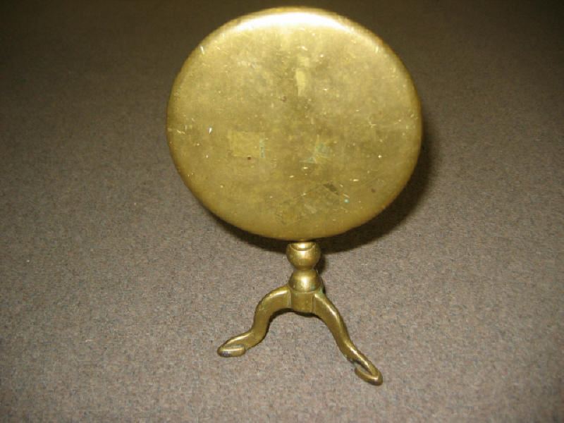 Appraisal: BRASS CANDLE REFLECTOR Tilt top table form showing the circular