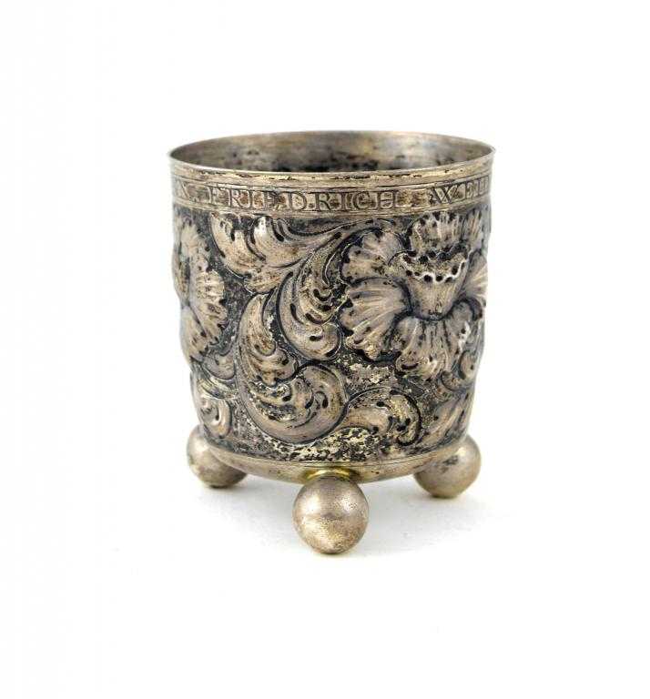 Appraisal: A GERMAN REPOUSS BEAKER chased with flowers and luxuriant foliage