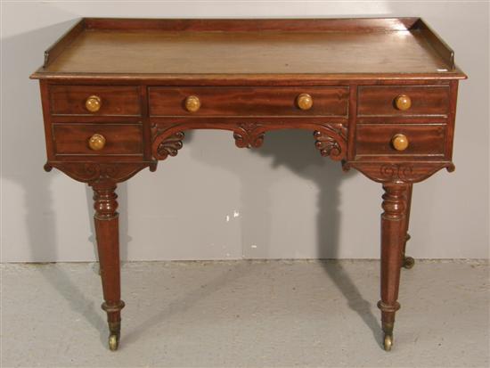 Appraisal: Mahogany dressing table th century with raised gallery five drawers