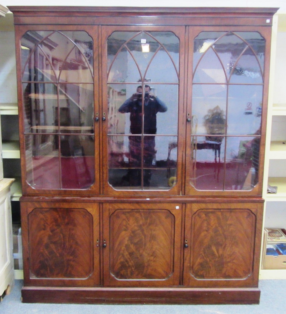 Appraisal: A William IV mahogany bookcase cupboard the three Gothic arch