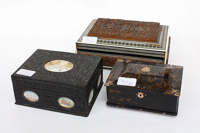 Appraisal: AN EDWARDIAN INDIAN EBONY CARVED BOX set with oval miniatures