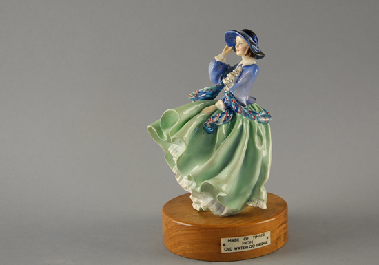 Appraisal: A Porcelain Figure of a Lady with blowing green skirts