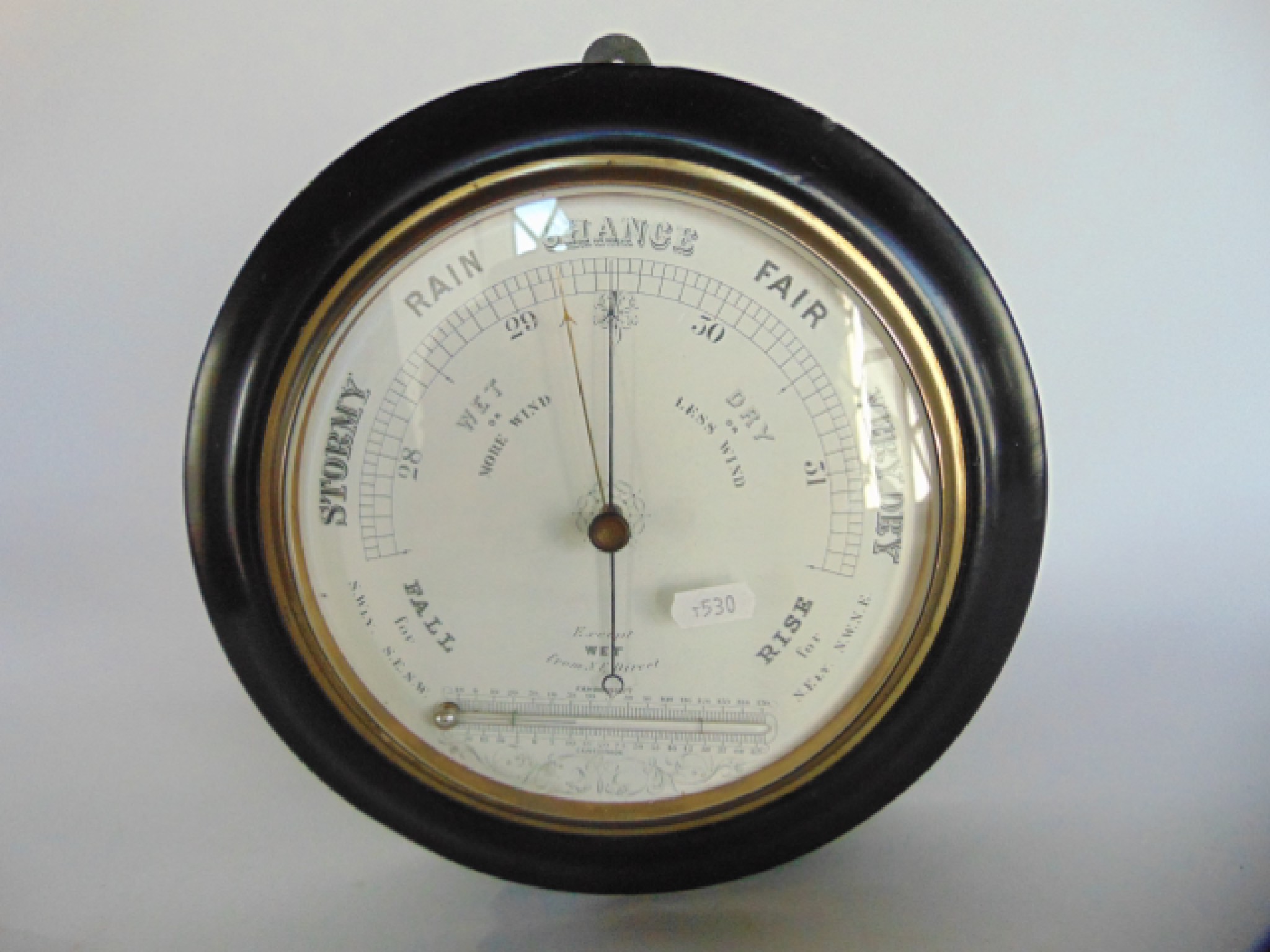 Appraisal: An Edwardian aneroid barometer with printed dial incorporating a horizontal