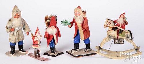 Appraisal: FIVE SANTA FIGURESFive Santa figures to include a figure riding