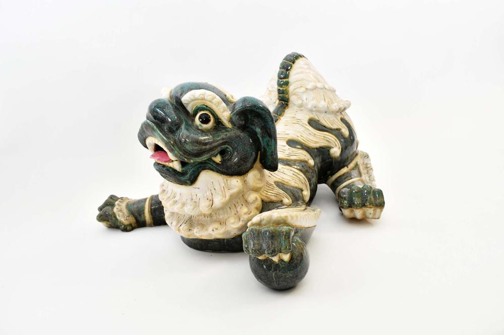 Appraisal: CHINESE STONEWARE FU-DOGRecumbent on all four legs with a sphere