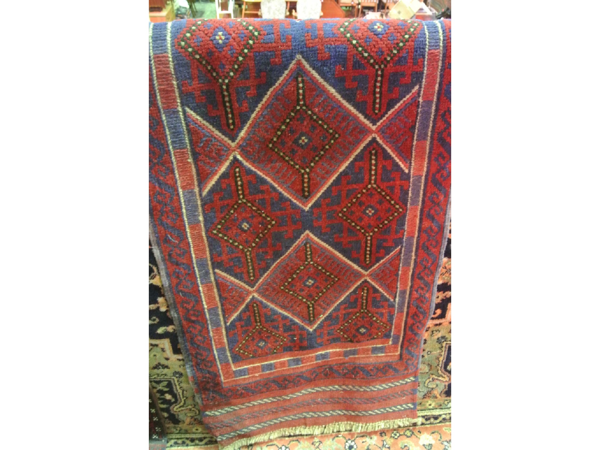 Appraisal: An eastern woven wool runner with central medallion detail in